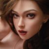 Close-up portrait of a woman with smoky eyes, glossy red lips, and gold hoop earrings, touching her hair.