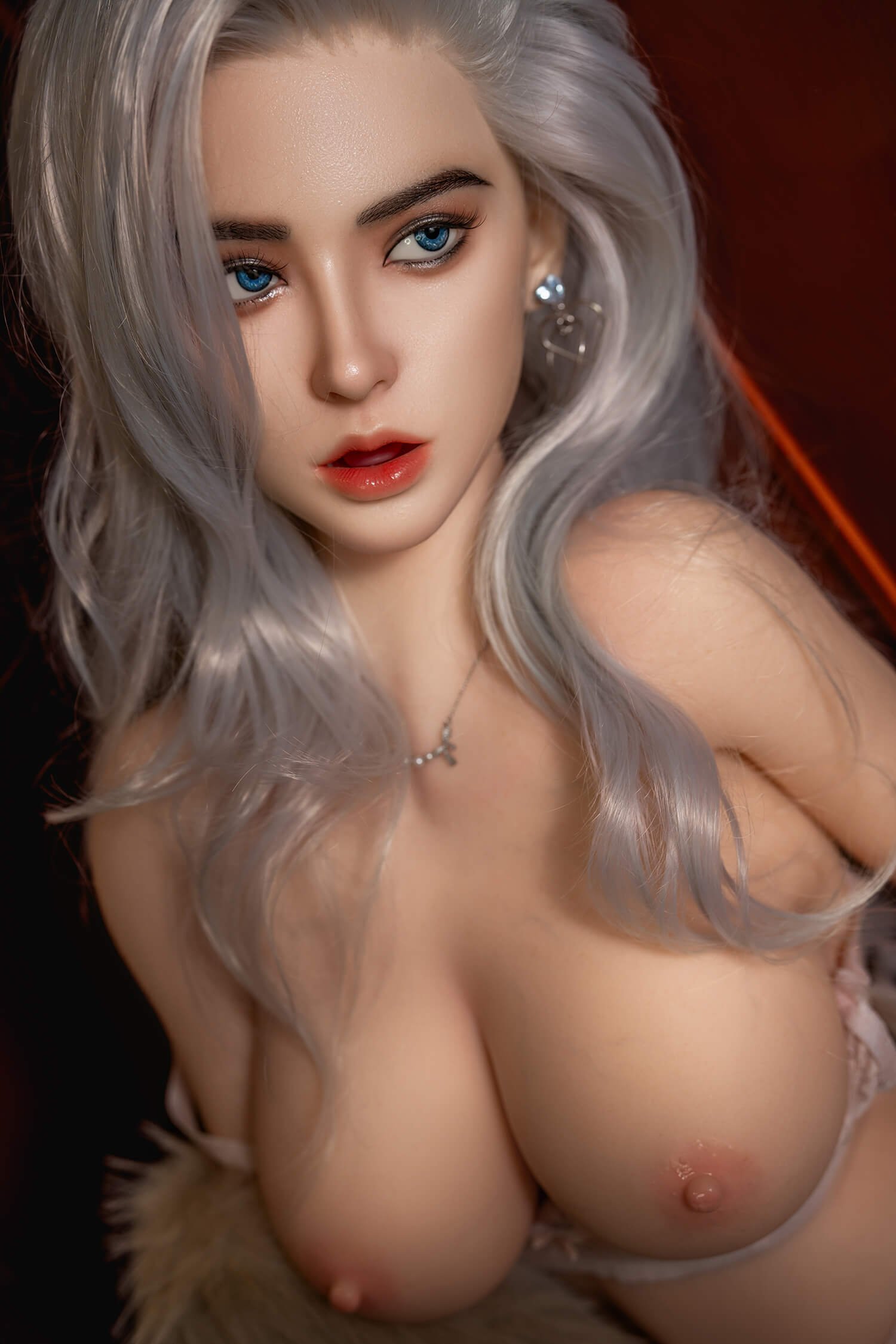Close-up portrait of a topless woman with long silver hair and blue eyes, looking to the left.