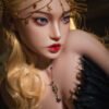 Close-up portrait of a person with golden hair wearing a gold chain headpiece with star charms and a black feathered outfit, looking to the side.