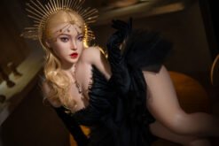 Model in a black feathered gown reclining, wearing a gold sunburst headpiece and bold red lips.
