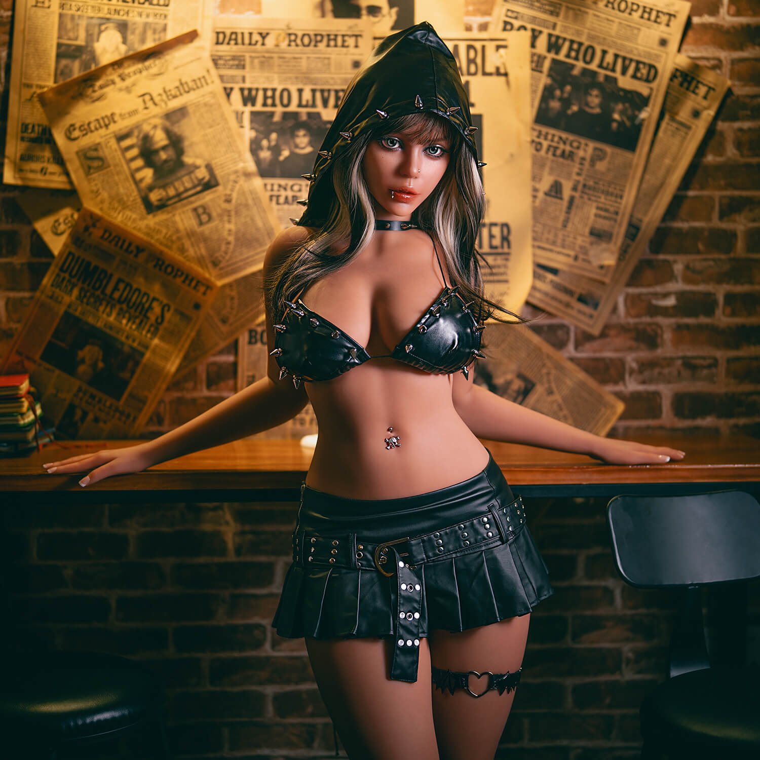 Woman in a spiked black leather bikini top, hood, and choker, standing at a wooden bar with a newspaper-covered wall behind her.