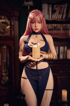 Lifelike doll with pink hair and gold accessories holds a lit candle in a dim, book-filled room.